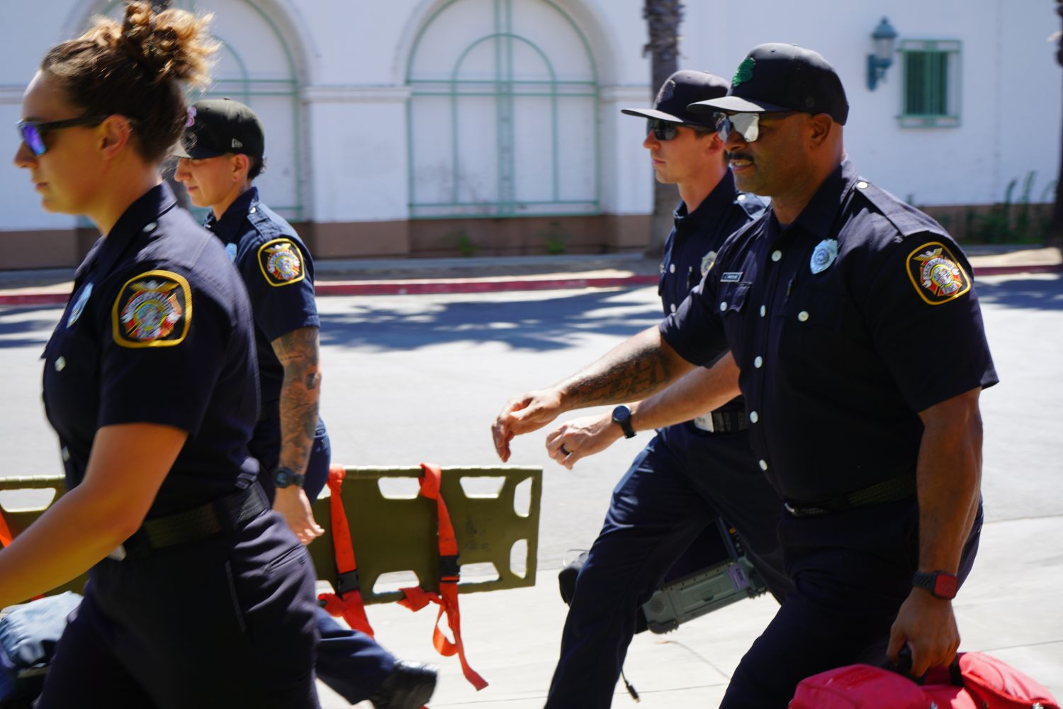 Four paramedics in uniform walking to an emergency 