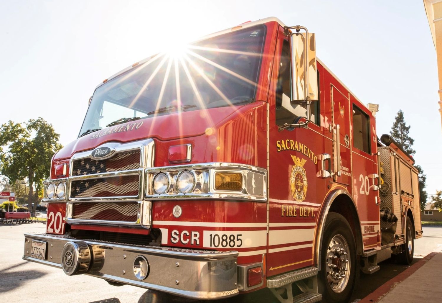 Red fire engine parked with the sun reflecting off the windshield