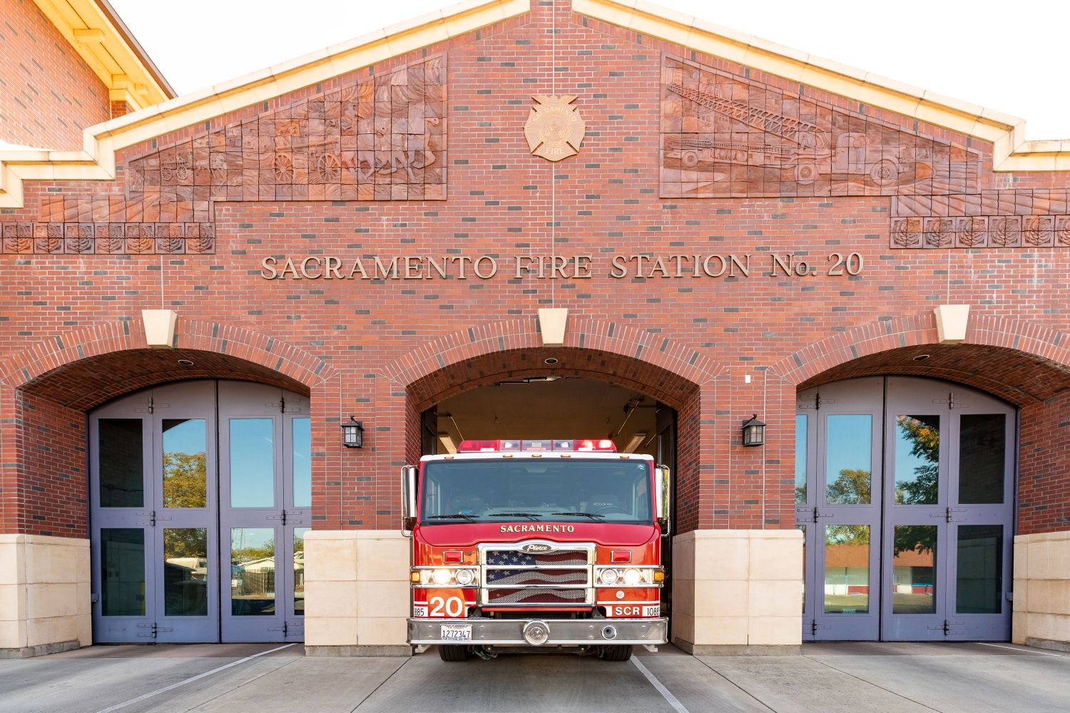 front of station 20, a brink building with glass doors and a fire engine in the middle