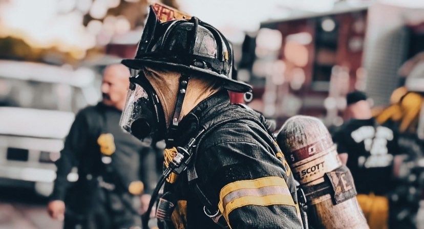 Firefighter in turnouts walking and profile view