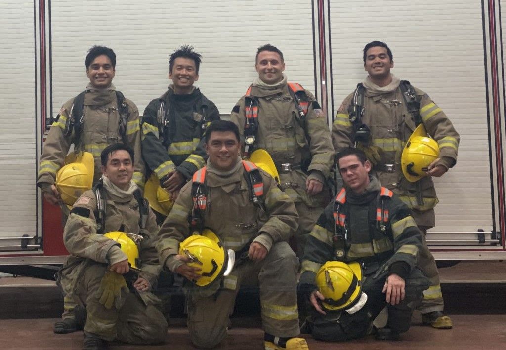 Reserves in turnouts posing on the side of an engine