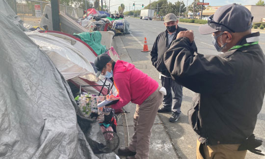 A homeless encampment on the sidewalk