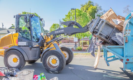 Junk pickup, picking up trash and putting it in dumpster
