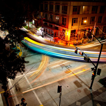 Evening photo of a light rail train with an open shutter effect.