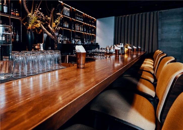 Restaurant bar scene, bar top, glasses, bar stools