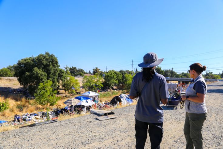 Two City staff members at large encampment 