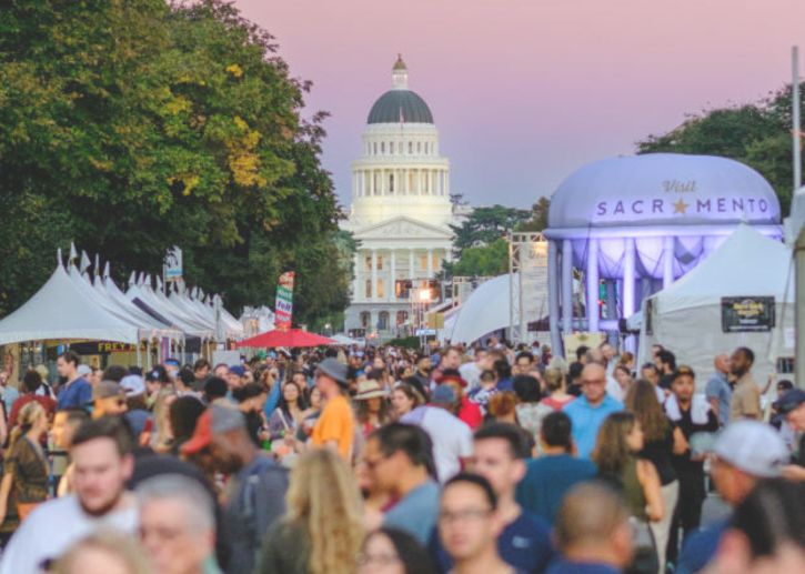 Large crowd of people at outdoor event, Sacramento Capitol, vendor booths