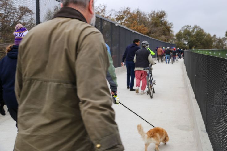 People walking across Del Rio Bridge during celebration