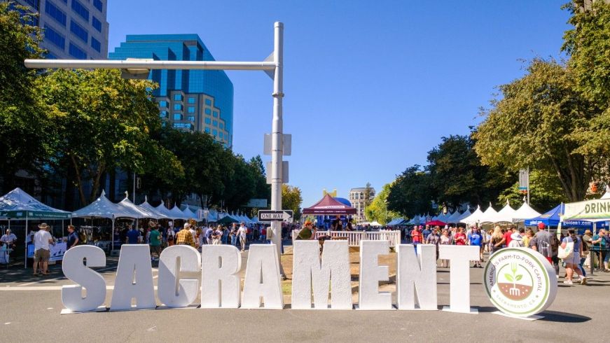 Large Sacramento sign, Farm to Fork event, trees, buildings