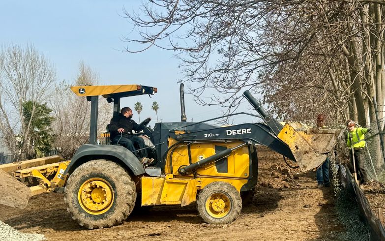 Tractor breaking ground, dirt, trees