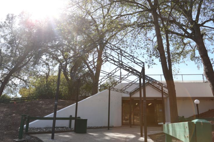 Outreach and Engagement Center, white building, trees