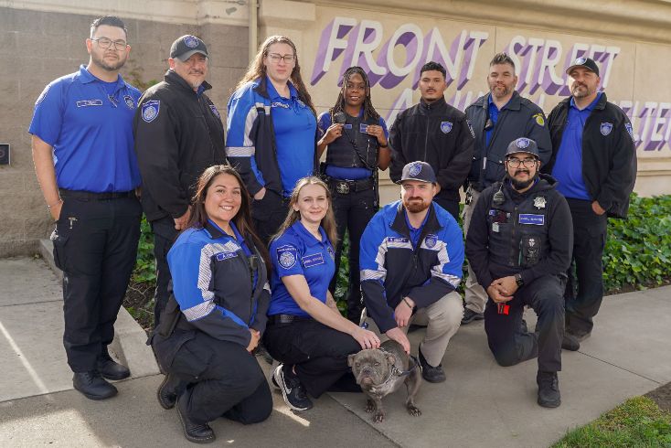 Group photo of animal service officers with dog in center