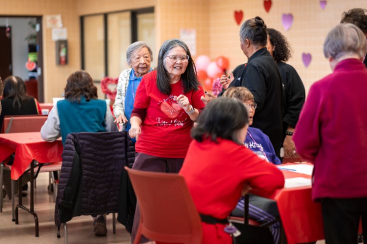 Older adults talking and mingling around tables