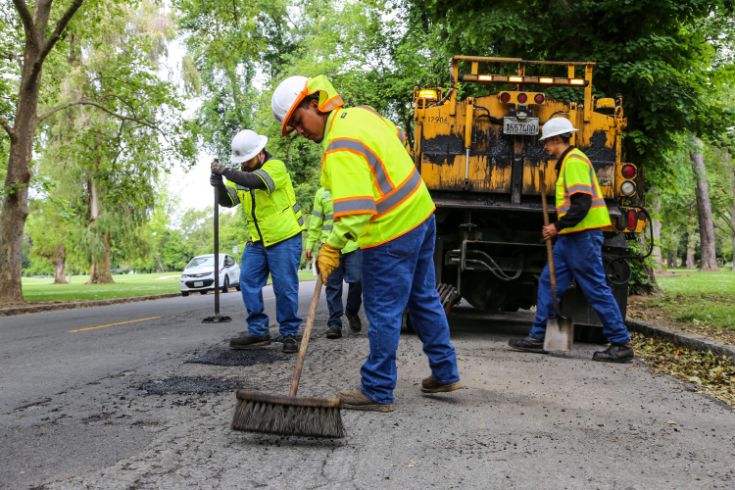 City workers repairing pothole while wearing neon vests, street, truck, 