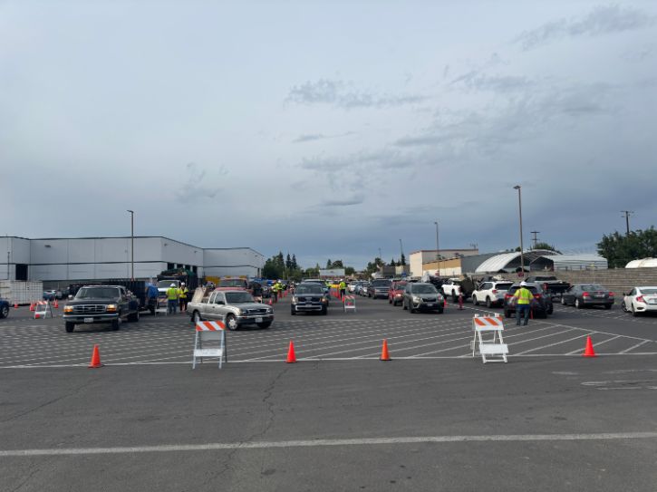 Parking lot, traffic cones, cars, City workers