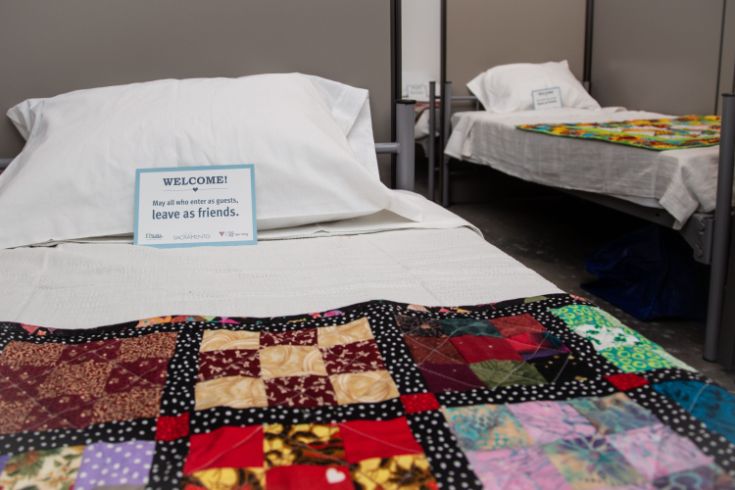 Bed at shelter space, quilt, pillows