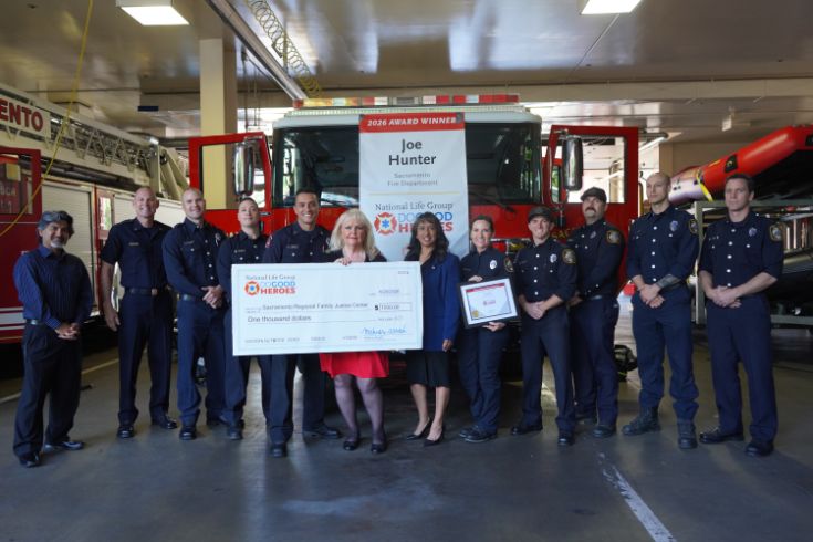 Group photo of Sacramento Firefighters with person holding check in center, text "Do Good Heroes"