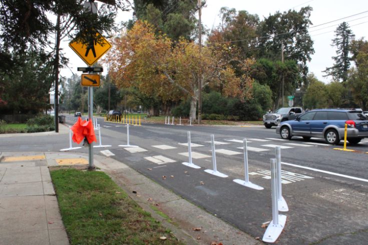Street, bike lane, cars, sidewalk, crosswalk, street signs