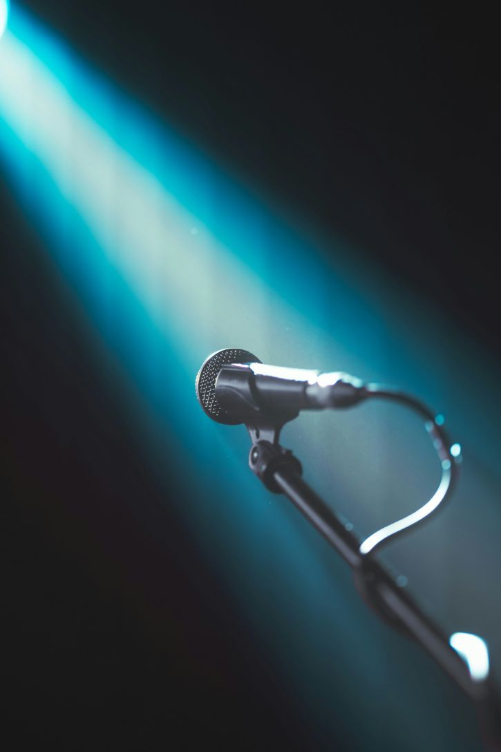 Microphone, blue background and spotlight