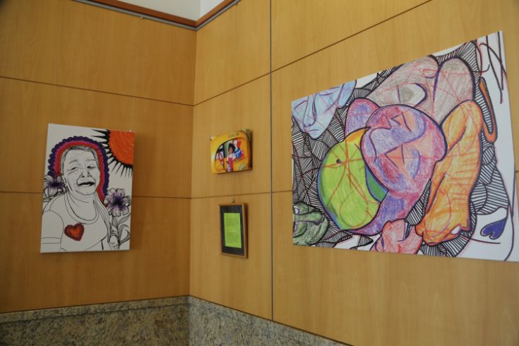 paintings hanging on wall of exhibit