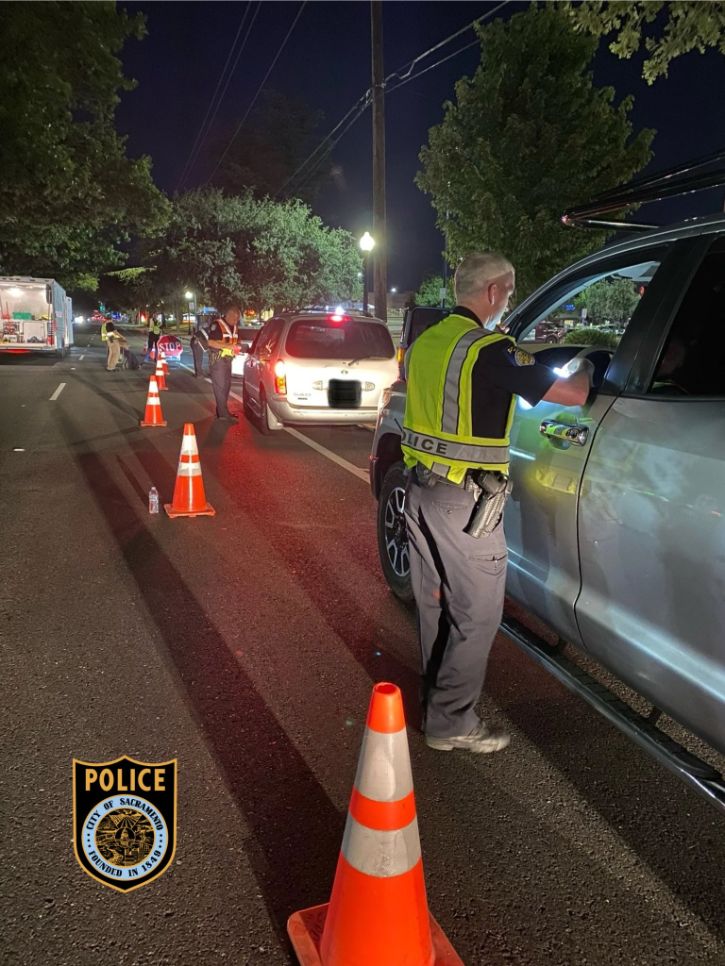 DUI checkpoint, traffic cones, cars pulled over, police officers