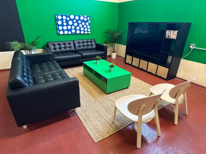 Coffee table, sofa, chairs, green wall