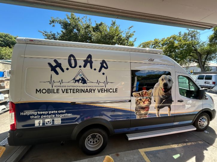 blue and white van with photo of dog and cat