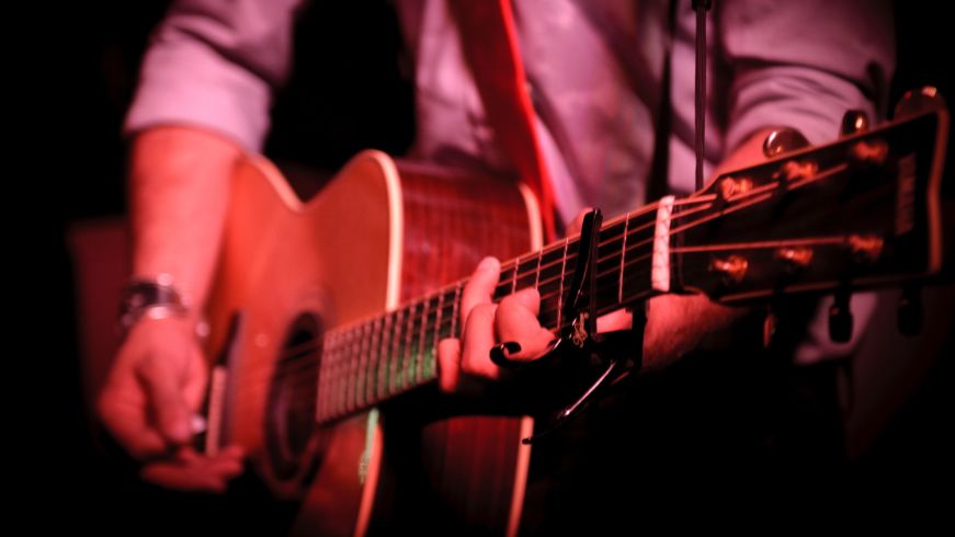 Person playing acoustic guitar