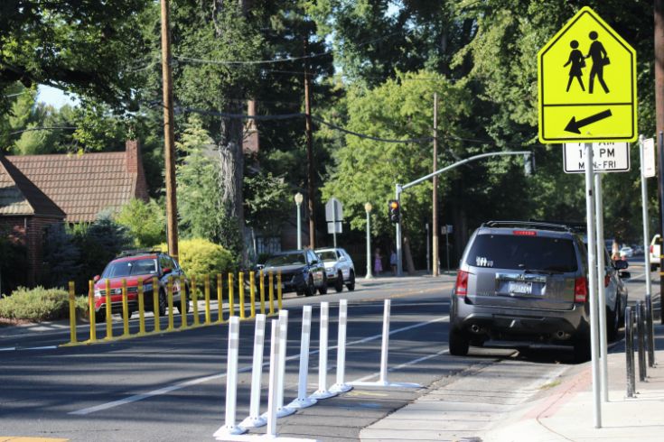 Street, cars, trees, crosswalk sign