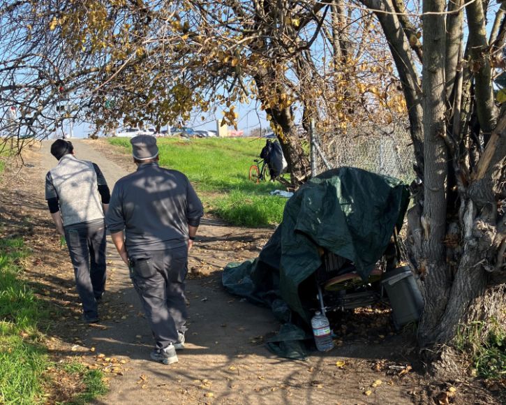 City staff walking through encampment 