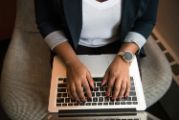 hands typing on laptop keyboard