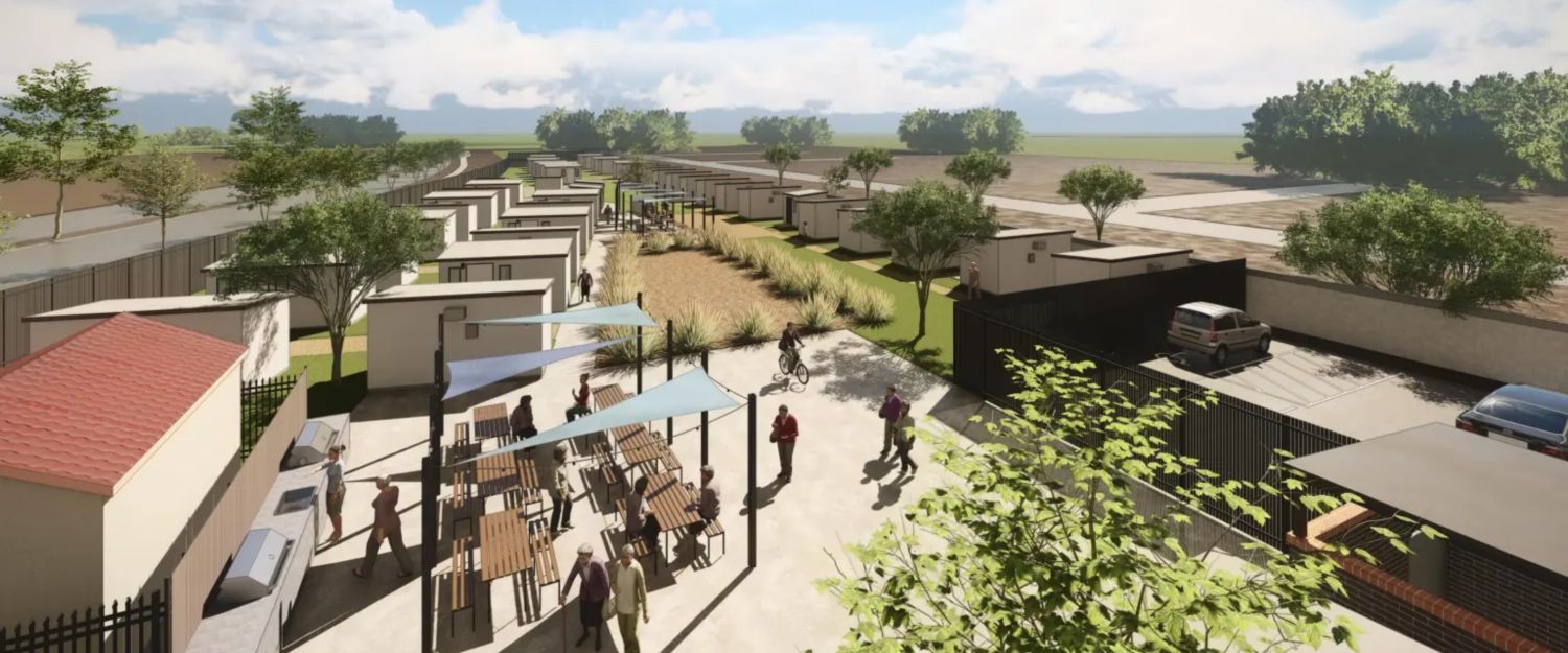 Birds-eye view of a micro-community with grass, walkways, homes, kitchen facilities, tables,, and parking.