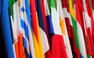 A row of colorful flags draped side by side