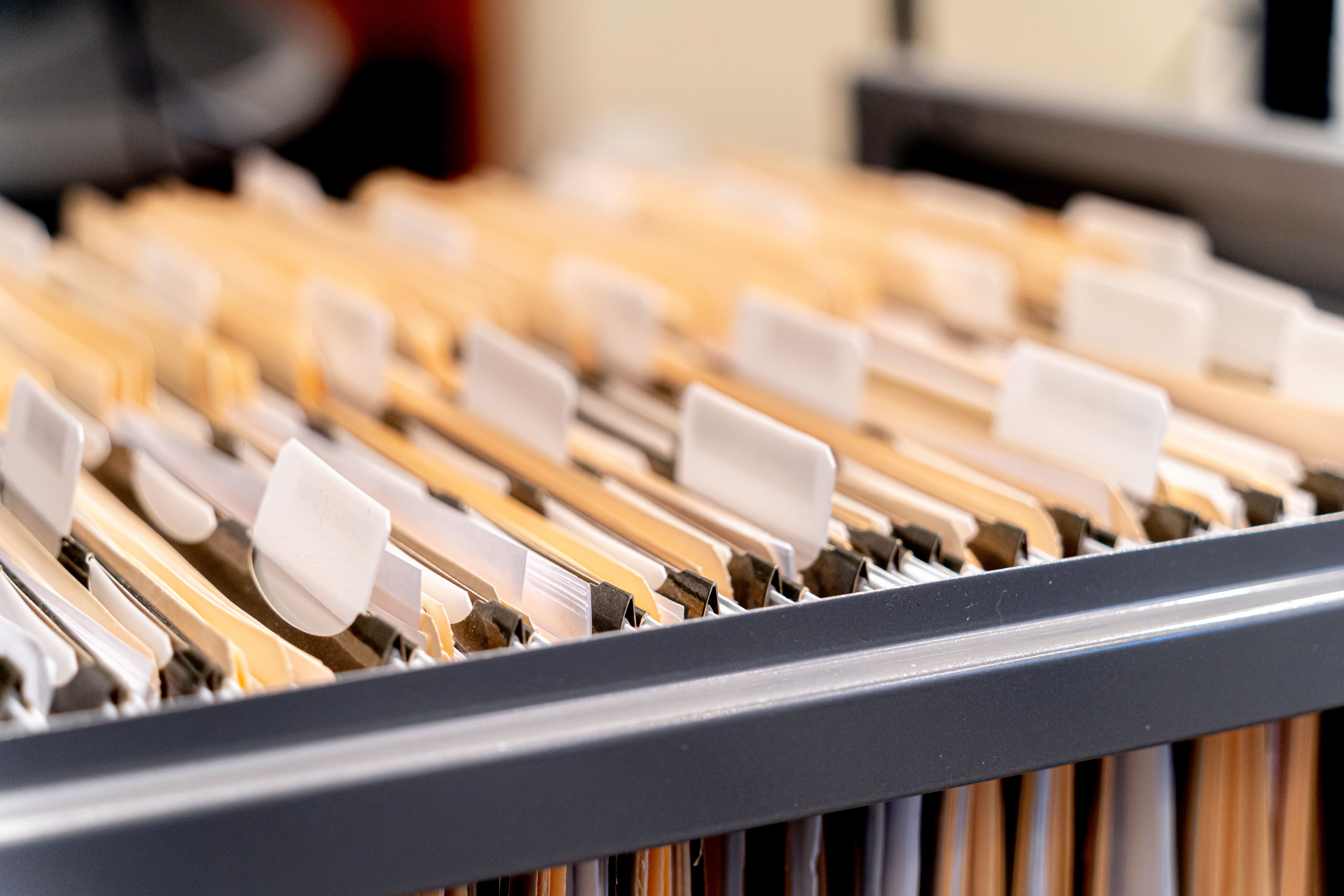 A photo of manila file folders in an open cabinet drawer