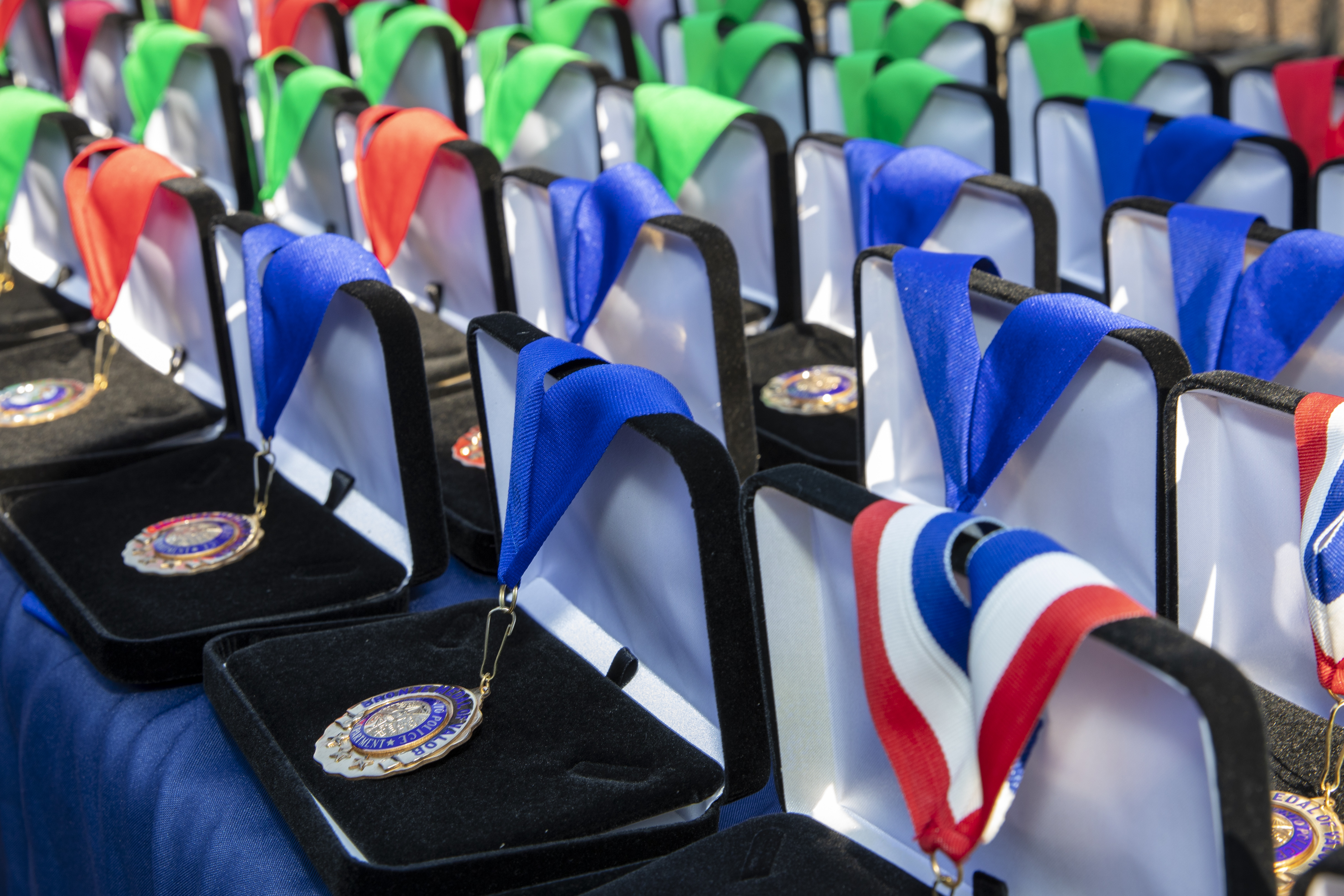 Photo of commendation award medals with ribbons in boxes on a table