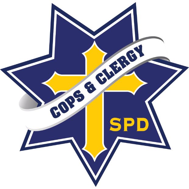 Sacramento Police Department Cops and Clergy Logo. This logo is a blue seven pointed start, with a blue and white border. within the star is a yellow cross, and the letters SPD in letter.s there is a diagonal banner across the star and cross which is white, and says "cops and clergy" in blue.