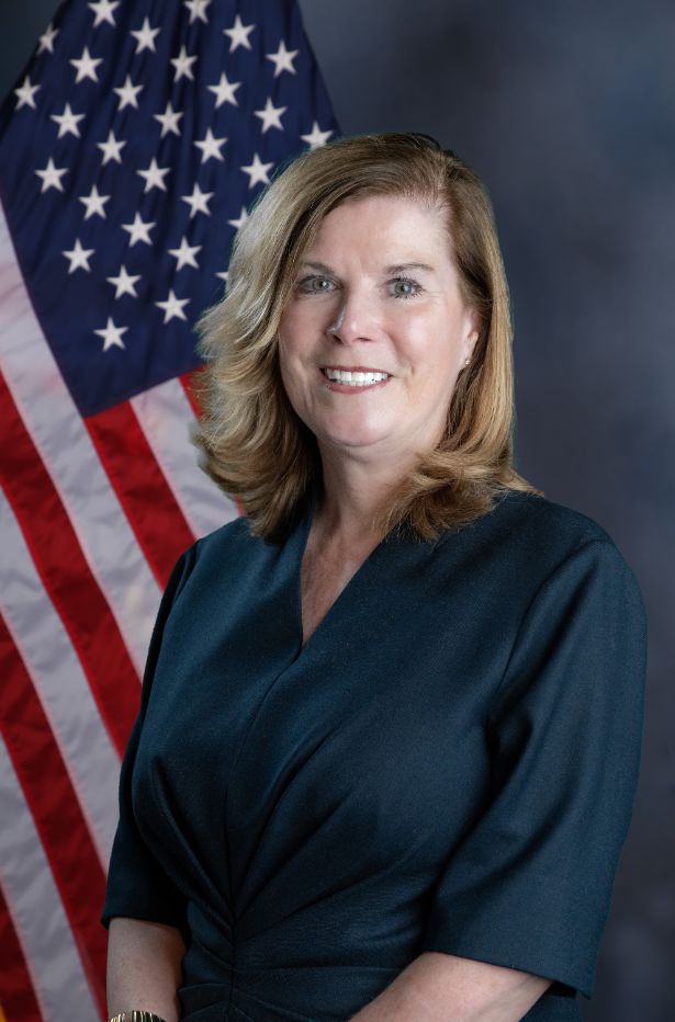 A photo of Chief Blake Norton in front of an american flag