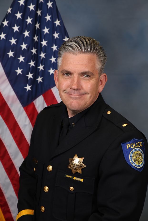 Photo of Joe Bailey in uniform standing in front of the American flag.