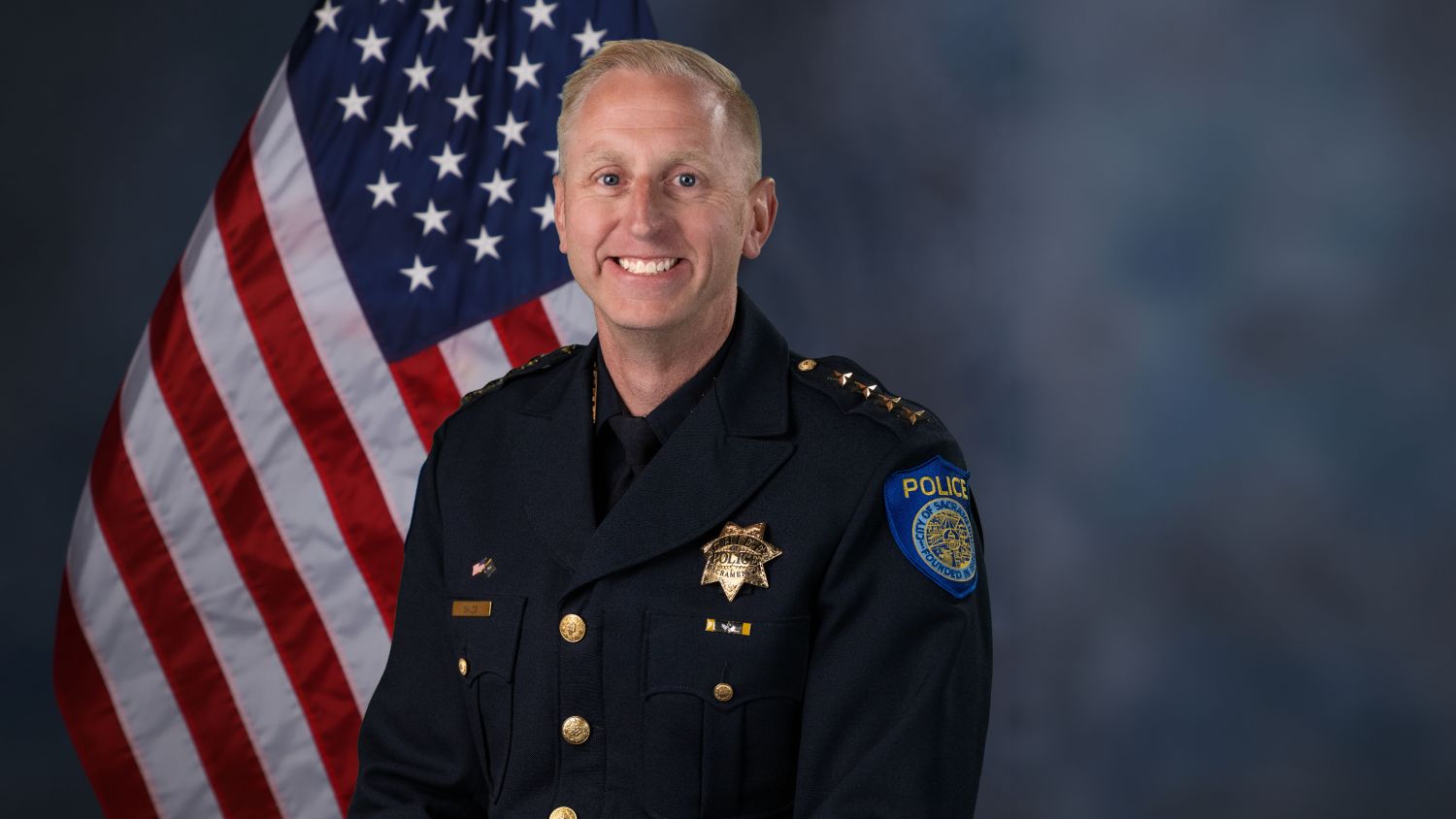 A portrait photo of the Sacramento Police Department Interim Chief of Police, Zachary Bales, in full class-A uniform