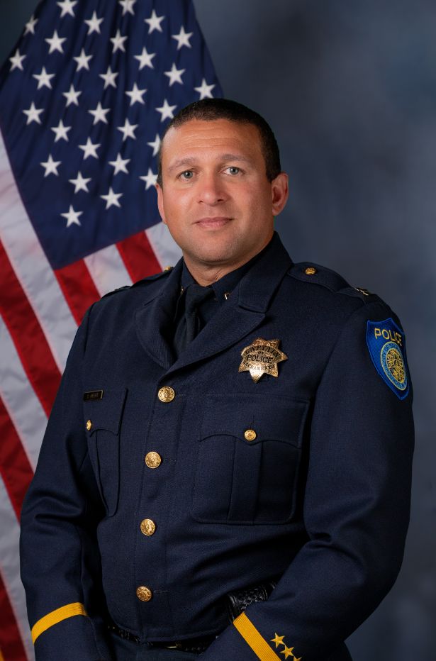 Photo of Captain Stephen Moore in uniform with the American flag in the background