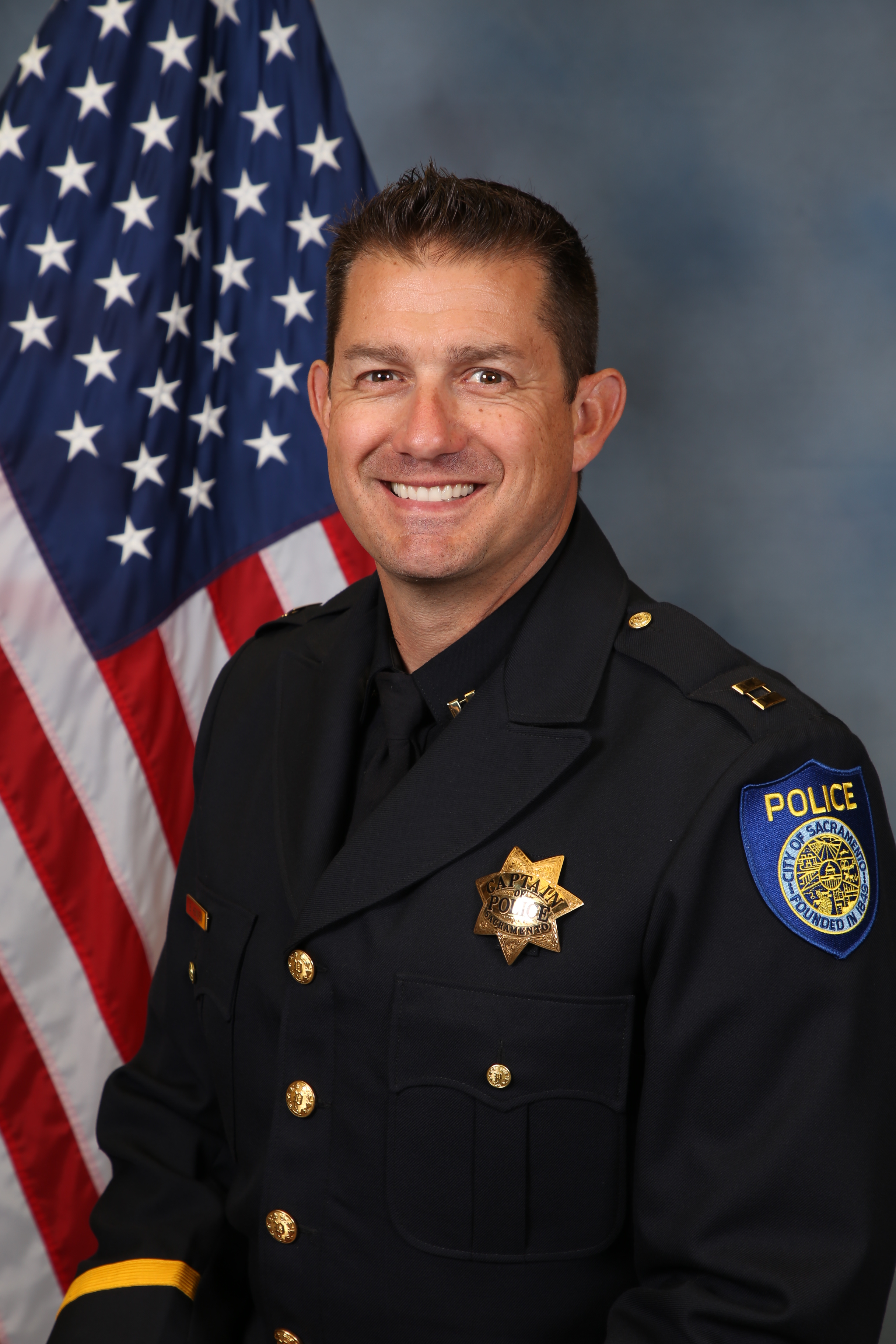 A portrait photo of the Sacramento Police Department Captain Bryce Heinlein, in full class-A uniform