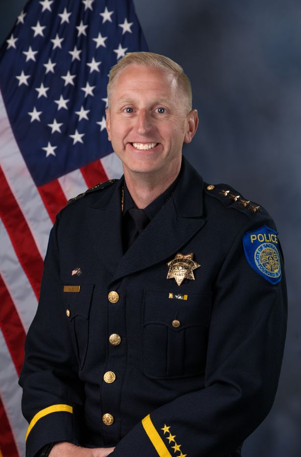 Photo of Zack Bales in uniform with the American flag in the background