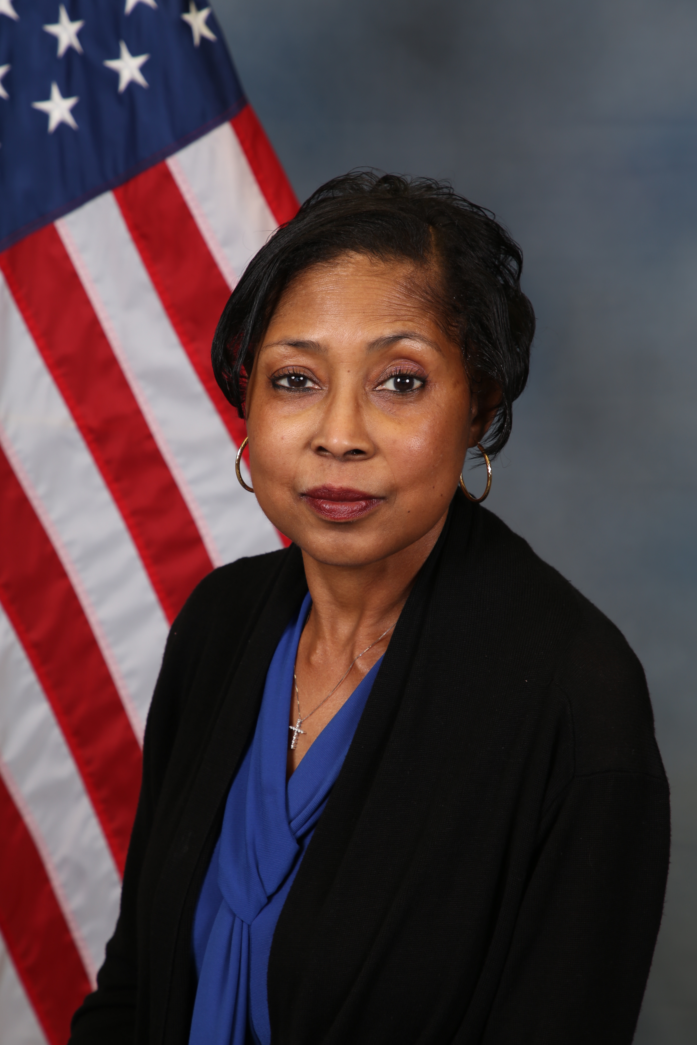 Photo of Tammy Jones in front of the American flag.