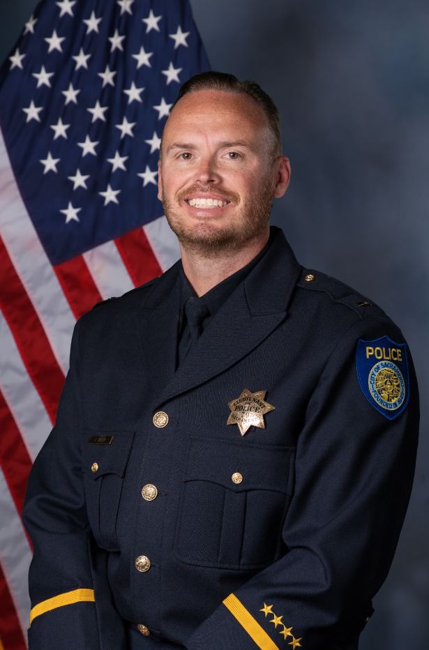 Photo of Lt. Kiser in class "A" uniform in front of the American flag