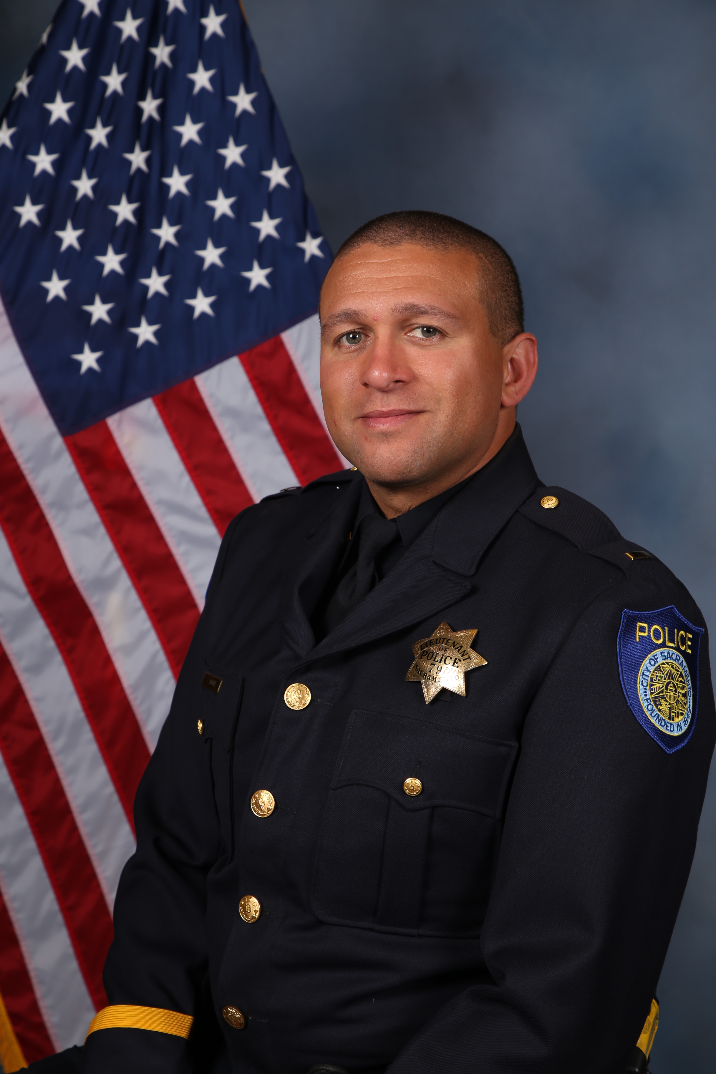 A portrait photo of the Sacramento Police Department Captain Stephen Moore, in full class-A uniform