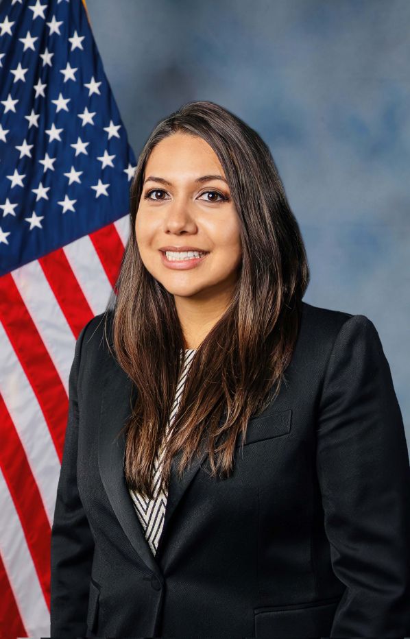 Photo of Nancy Molina with the american flag in the background 