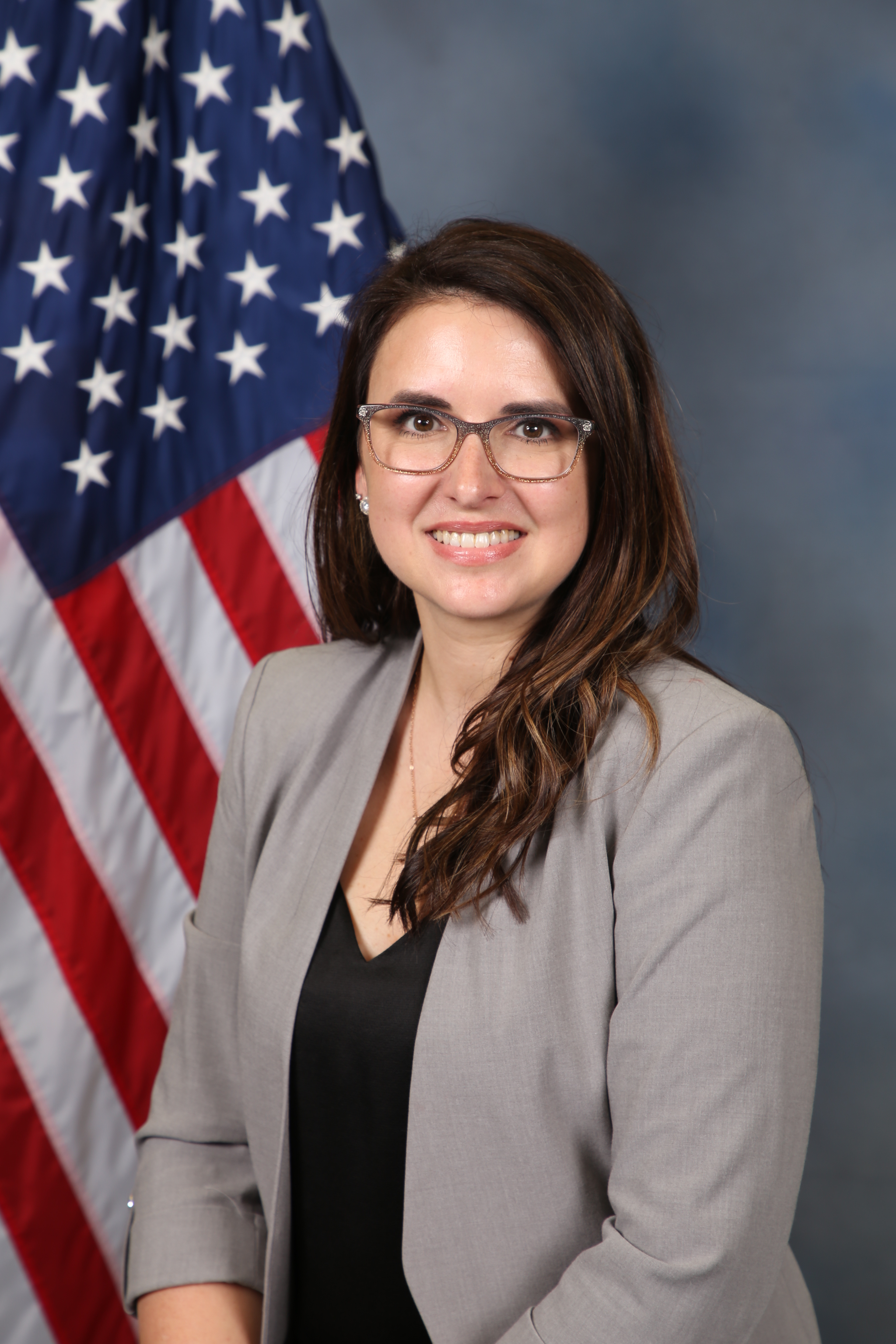 Photo of Danielle Perez in front of the American flag.