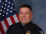 A portrait photo of the Sacramento Police Department Acting Lieutenant Todd Culp, in full class-A uniform