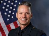 A portrait photo of the Sacramento Police Department Lieutenant Joshua Dobson, in full class-A uniform