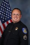 A portrait photo of the Sacramento Police Department Lieutenant Jared Kiser, in full class-A uniform